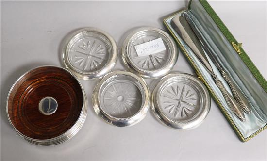 A silver coaster, four others, a cased shoe horn and button hook